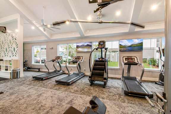 the gym is equipped with cardio machines and a large window at Watermark at Urban Blu, Panama City Beach, Florida
