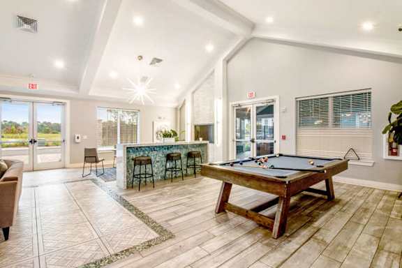 a game room with a pool table and a bar at Watermark at Urban Blu, Panama City Beach, Florida