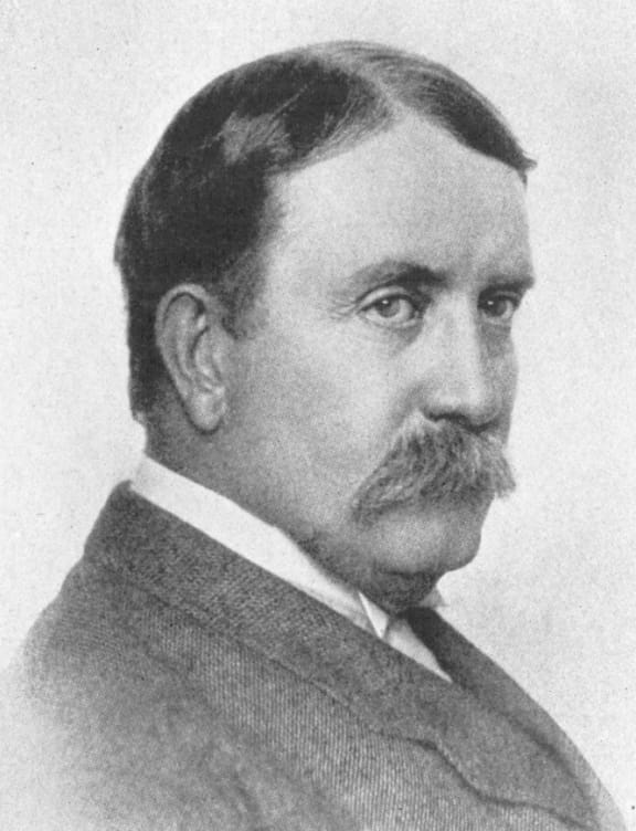 a black and white photo of a man with a mustache