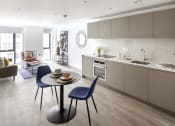 Thumbnail 7 of 12 - a kitchen and living room with a table and chairs