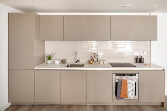 a white kitchen with stainless steel appliances and white cabinets
