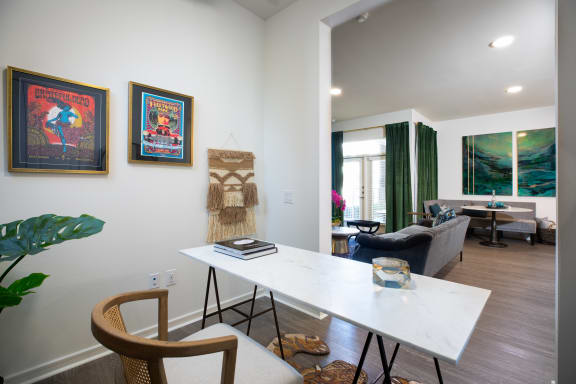 a home office with a white desk and two chairs