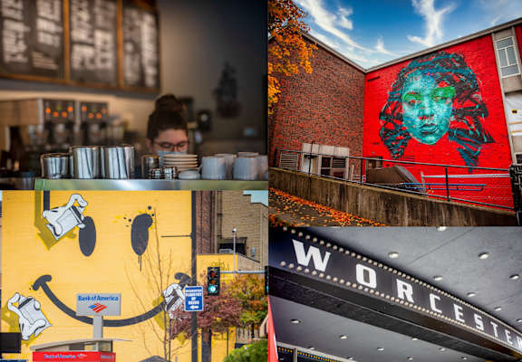 A mural of a face on a red wall and a black building with the word "WORCESTER" on it.
