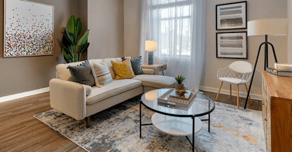 a living room with a couch and a coffee table  at The Cosmopolitan, St Paul, MN, 55101