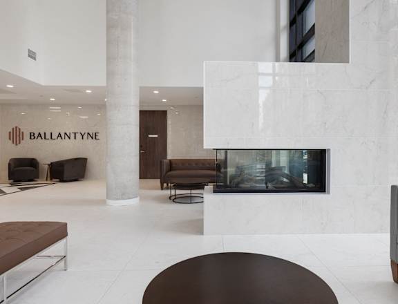 A modern living room with a fireplace and a sign that says "Ballantyne".