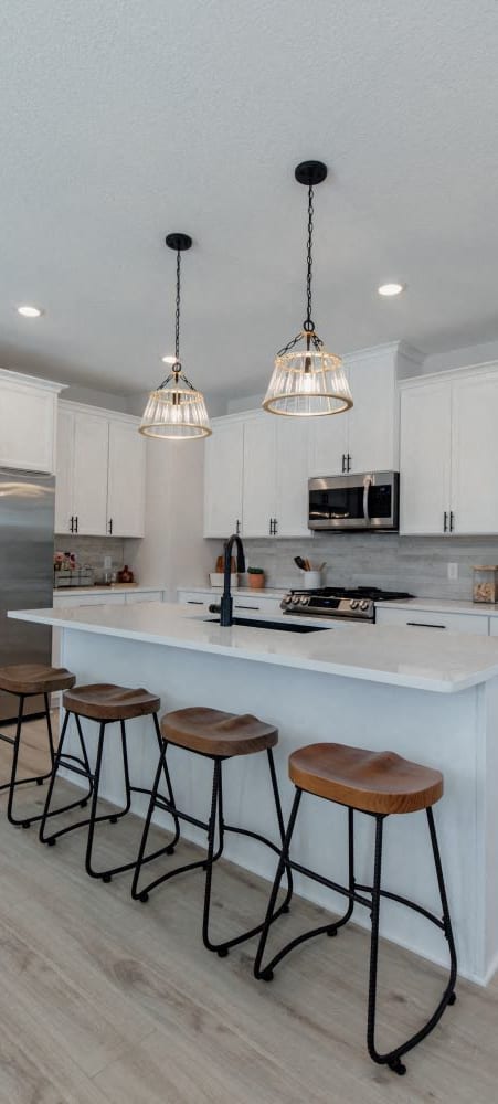 a kitchen with a table and chairs in front of a counter