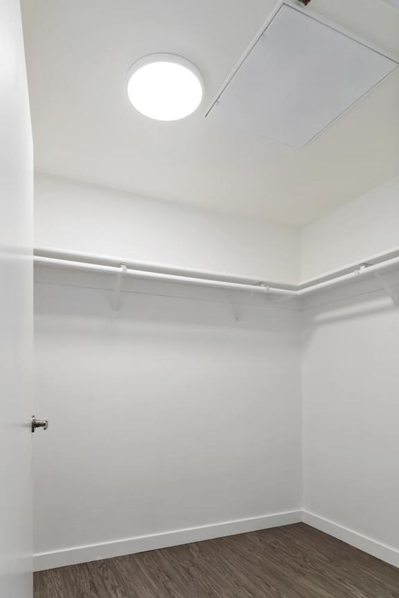 A closet with a white door and a white ceiling with a light fixture at Fusion Hollywood.
