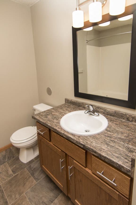 Bathroom with tile floor and granite counters at Highland View