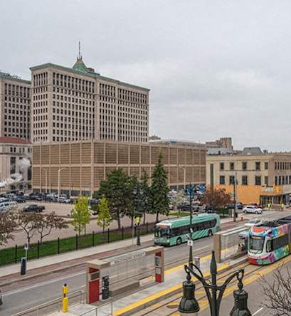 A city street with a bus and a white van.