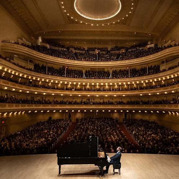 A man is playing the piano at MARC Apartments, New York, NY, 10019