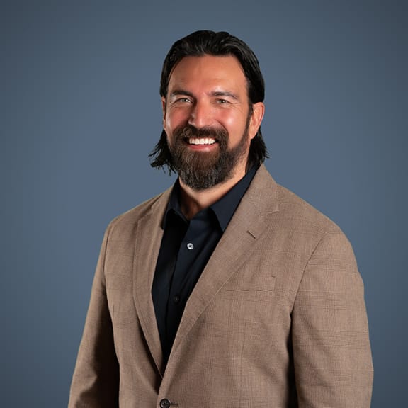 a man in a suit smiling at the camera