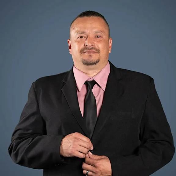 a man in a suit and tie posing for a picture