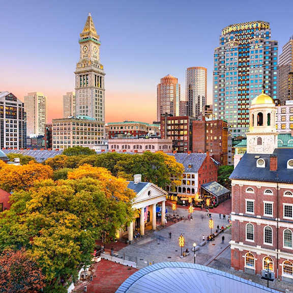 A cityscape with a clock tower and a building with a golden dome.
