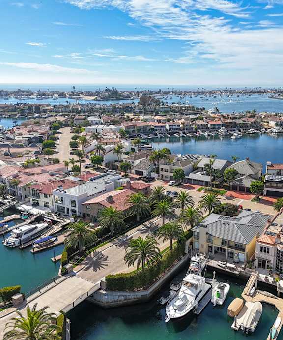 A marina with boats docked in the water and buildings surrounding it.