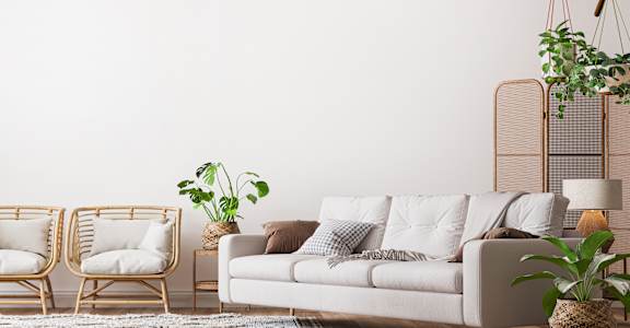 a living room with a white couch and two chairs