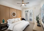 Thumbnail 16 of 19 - a bedroom with a large white bed and a large painting on the wall