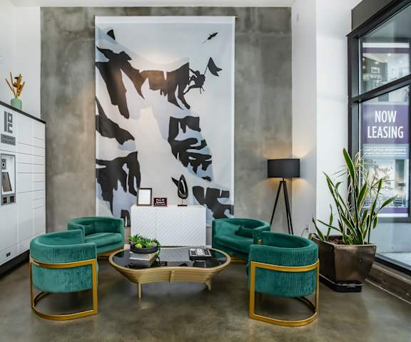 A modern office lobby with green chairs and a large poster on the wall.