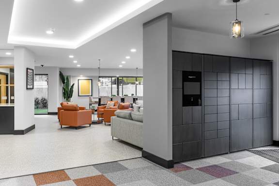 a lobby with couches and chairs and a black door