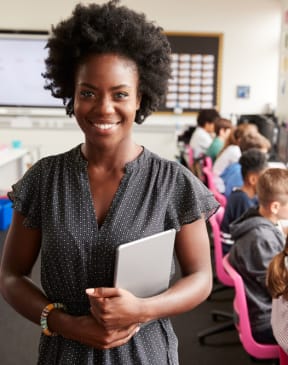 a teacher standing in front of a classroom of students