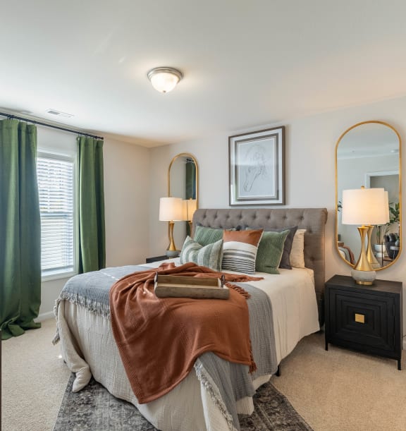 a bedroom with a large bed and green curtains