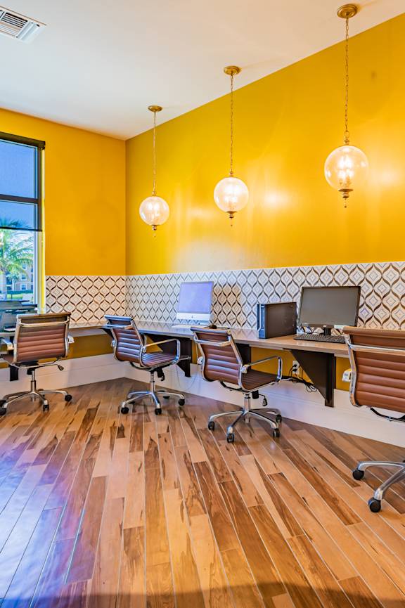 A reception area with a piano and chairs.