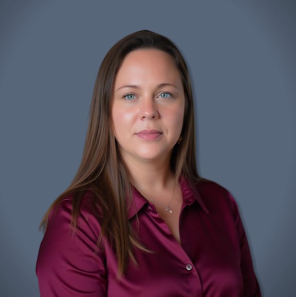 A woman with brown hair wearing a purple shirt.