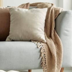 a living room with a couch and pillows on it