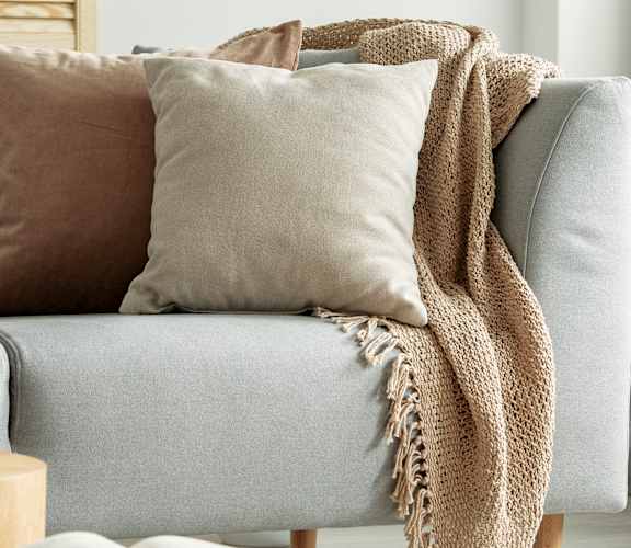 a living room with a couch and pillows on it