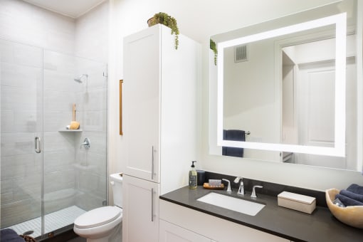 a bathroom with white walls and a black countertop