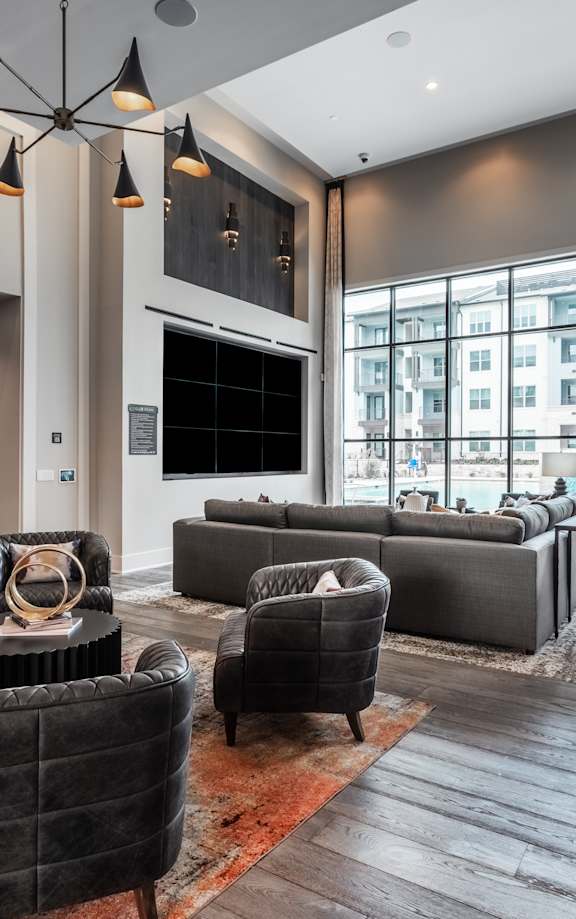 a large living room with couches and chairs and a large window