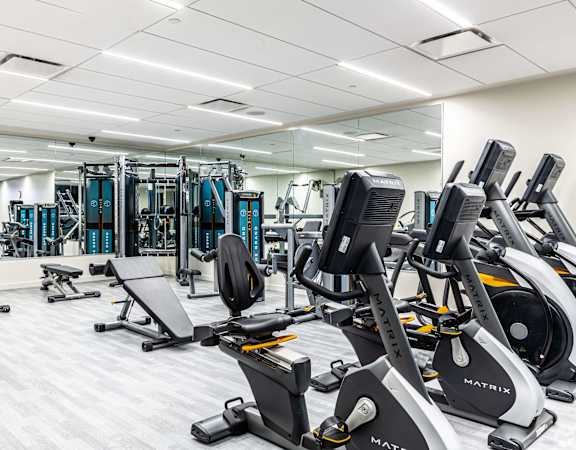 a gym with various exercise bikes and other gym equipment  at The Grand, Missouri, 64106