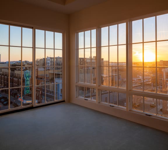 An empty room with large windows and a view of the city at Mercantile on Broadway, Fargo, ND, 58102