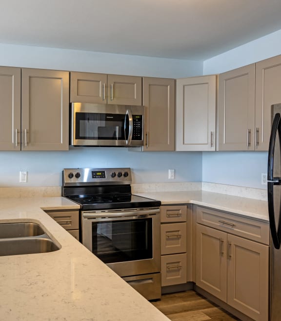 a kitchen with granite counter tops and stainless steel appliances