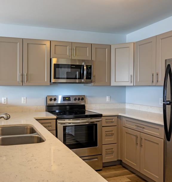 a kitchen with granite counter tops and stainless steel appliances