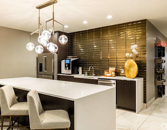 a kitchen with a large white counter and chairs  at The Grand, Missouri