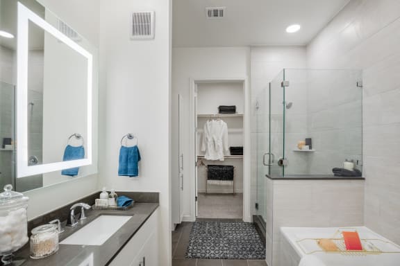 a bathroom with a tub and a shower with a glass door