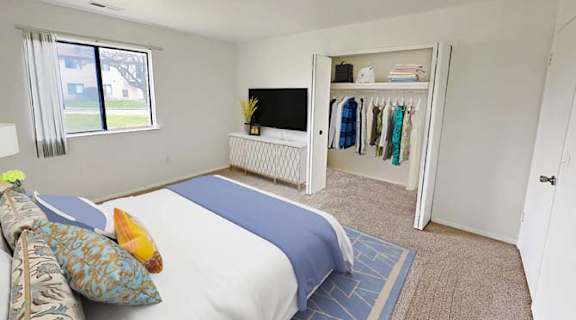 a bedroom with a bed and a tv in it