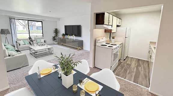 a living room and kitchen with a table and chairs