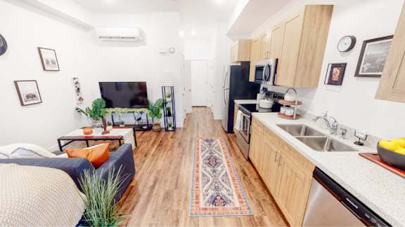 A kitchen with a refrigerator, sink, and stove is shown. 605 Place Student Housing & Co-Living, Utah