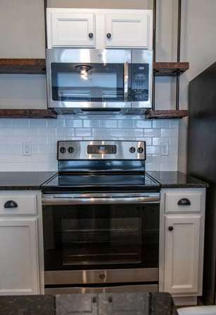 a kitchen with stainless steel appliances and white cabinets