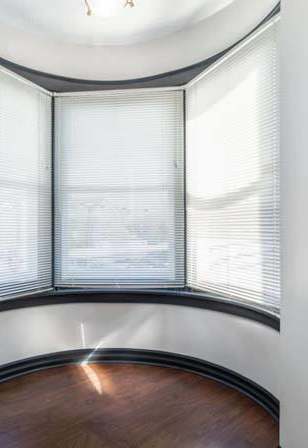 an empty room with a large bay window
