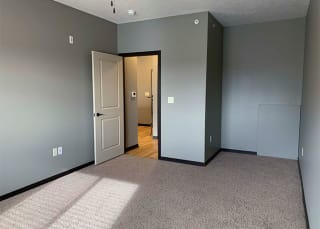 Large bedroom with ceiling fan and walk in closet in a 1 bedroom apartment for rent at The Flats at 84 best apartments Lincoln NE 68516