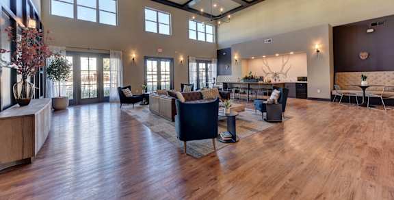 A living room with a white couch and a coffee table. at Bridge at Speyside Apartments, Austin, TX, 78754