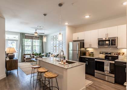 A modern kitchen with a bar stool and a countertop.
