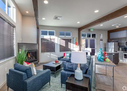 a living room with a fireplace and couches at COPPER PLATTE Apartments, GREELEY , CO 80631