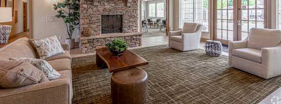 a living room with a stone fireplace and a couch