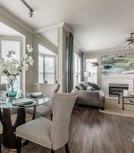 A dining room with a glass table and chairs.