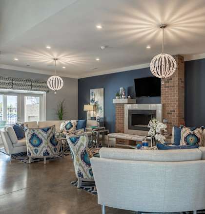 a living room with blue and white furniture and a fireplace