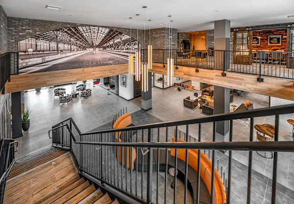 A modern interior with a staircase and a large mural on the wall.at Parkway Crossings, Kissimmee