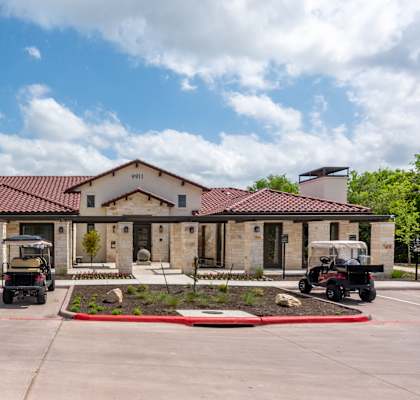 the front of a building with two golf carts in a parking lot